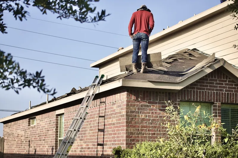 Professional roofer working on a residential roof in Valley Forge Homes